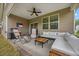 Covered outdoor patio featuring comfortable seating, a ceiling fan, and a grill for outdoor dining at 247 Axis Deer Ln, Garner, NC 27529