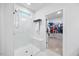 Bright, tiled shower with glass door and modern fixtures leading to a walk-in closet at 247 Axis Deer Ln, Garner, NC 27529