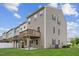 Exterior shot of a multi-level townhouse featuring a wooden deck and a concrete patio at 260 Amber Acorn Ave, Raleigh, NC 27603