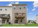 View of the back of a two-story home featuring a wooden deck and a concrete patio at 260 Amber Acorn Ave, Raleigh, NC 27603