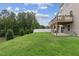 A sprawling backyard with lush lawn, trees, and fencing, providing privacy and a peaceful environment at 260 Amber Acorn Ave, Raleigh, NC 27603