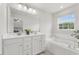 Bright bathroom with double sink vanity and a soaking tub at 260 Amber Acorn Ave, Raleigh, NC 27603