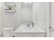 Bright and modern bathroom with a large mirror, dual sinks, and white fixtures at 260 Amber Acorn Ave, Raleigh, NC 27603