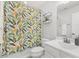Bright bathroom with tropical print shower curtain and modern shelving at 260 Amber Acorn Ave, Raleigh, NC 27603