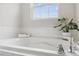 Clean white bathtub with chrome fixtures and subway tile backsplash at 260 Amber Acorn Ave, Raleigh, NC 27603