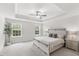 Spacious bedroom with trey ceiling, large windows, and a ceiling fan at 260 Amber Acorn Ave, Raleigh, NC 27603