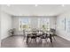 Bright dining room features a modern dining table and large windows at 260 Amber Acorn Ave, Raleigh, NC 27603