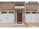 A welcoming front door flanked by a two-car garage, with clean lines and brick accents at 260 Amber Acorn Ave, Raleigh, NC 27603