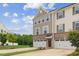 Attractive townhome with brick and siding, showcasing a two-car garage and landscaped front yard at 260 Amber Acorn Ave, Raleigh, NC 27603