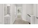 Hallway view showing carpeted floor, half bathroom and a view to the Primary bedroom at 260 Amber Acorn Ave, Raleigh, NC 27603