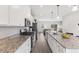 Bright, open kitchen with stainless steel appliances, granite countertops, and a central island at 260 Amber Acorn Ave, Raleigh, NC 27603