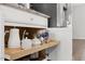 Coffee bar with a pull-out shelf and white cabinetry at 260 Amber Acorn Ave, Raleigh, NC 27603
