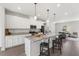 Spacious kitchen featuring stainless steel appliances, island seating, and open layout to the living area at 260 Amber Acorn Ave, Raleigh, NC 27603