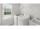 Modern laundry room featuring a washer, dryer, and utility sink at 260 Amber Acorn Ave, Raleigh, NC 27603