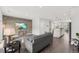 Open-concept living room features a wood-paneled accent wall, modern furnishings, and seamless flow to the kitchen at 260 Amber Acorn Ave, Raleigh, NC 27603