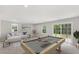 Bright living room with a pool table, white sofa, and sliding glass doors to the outside at 260 Amber Acorn Ave, Raleigh, NC 27603