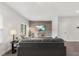 Cozy living room featuring a gray sofa, wood accent wall and a mounted TV at 260 Amber Acorn Ave, Raleigh, NC 27603