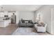 Bright living room with modern sofa, white armchair and stylish area rug at 260 Amber Acorn Ave, Raleigh, NC 27603