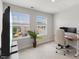 Bright office with two windows, a desk, rolling chair and large mounted TV at 260 Amber Acorn Ave, Raleigh, NC 27603