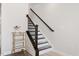 Staircase with modern railings and a decorative bar cart with gold accents at 260 Amber Acorn Ave, Raleigh, NC 27603