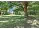 Picturesque backyard featuring a mature tree providing ample shade over a lush green lawn at 28 White Oak Dr, Smithfield, NC 27577