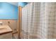 Retro bathroom showcasing blue walls and a shower with a blue and white polka dot curtain at 28 White Oak Dr, Smithfield, NC 27577