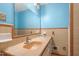Bathroom featuring a sink, mirror, and vintage peach and tan tiling at 28 White Oak Dr, Smithfield, NC 27577
