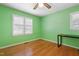 This bedroom features hardwood floors, a ceiling fan, and natural light at 28 White Oak Dr, Smithfield, NC 27577