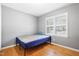 Bedroom with hardwood floors and large window with shutter blinds at 28 White Oak Dr, Smithfield, NC 27577