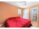 Bedroom boasts an orange wall, wood floors, and a red comforter at 28 White Oak Dr, Smithfield, NC 27577