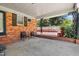 Inviting covered patio featuring brick accents, seating, and views of the outdoors for relaxing and entertaining at 28 White Oak Dr, Smithfield, NC 27577