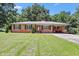 Charming brick home featuring a well-manicured lawn and a covered carport for convenient parking at 28 White Oak Dr, Smithfield, NC 27577
