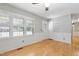 Bright living room featuring hardwood floors, fresh paint, and large windows with shutter blinds at 28 White Oak Dr, Smithfield, NC 27577