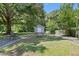 Backyard shed surrounded by mature trees and lawn at 28 White Oak Dr, Smithfield, NC 27577