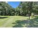 Spacious backyard with a lush green lawn, surrounded by mature trees, providing a private and serene setting at 28 White Oak Dr, Smithfield, NC 27577
