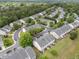 An aerial view showcases a community of townhomes nestled among mature trees and winding streets at 2950 Settle In Ln, Raleigh, NC 27614