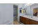 Bathroom featuring a double sink vanity, decorative fixtures, and a tiled shower/tub combo at 2950 Settle In Ln, Raleigh, NC 27614