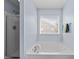 Bright bathroom with a soaking tub and a glass-enclosed shower at 2950 Settle In Ln, Raleigh, NC 27614