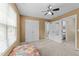 Bedroom featuring plush carpeting, a ceiling fan, and multiple closets for storage at 2950 Settle In Ln, Raleigh, NC 27614
