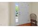 Bright entryway featuring a white door with sidelight and a wooden chair at 2950 Settle In Ln, Raleigh, NC 27614