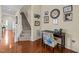 Foyer featuring hardwood floors, staircase, and desk area with pictures at 2950 Settle In Ln, Raleigh, NC 27614