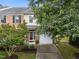 Charming brick and siding townhome featuring a one-car garage and well-maintained landscaping at 2950 Settle In Ln, Raleigh, NC 27614