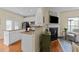 Modern kitchen with granite counters and stainless appliances opens up to living room at 2950 Settle In Ln, Raleigh, NC 27614