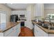 Well-lit kitchen featuring granite countertops, stainless steel appliances, and hardwood floors at 2950 Settle In Ln, Raleigh, NC 27614