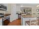 Open-concept kitchen with an island, stainless appliances, and adjacent dining area at 2950 Settle In Ln, Raleigh, NC 27614