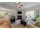Inviting living room featuring a fireplace, hardwood floors, and large window at 2950 Settle In Ln, Raleigh, NC 27614