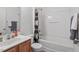 Bright bathroom showcasing a vanity, toilet and shower-tub combo with sports-themed curtain at 300 Gilman Ln # 101, Raleigh, NC 27610