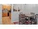 Cozy dining area showing table with chairs, hardwood floors, kitchen view and natural light at 300 Gilman Ln # 101, Raleigh, NC 27610