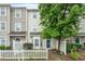 Charming townhome with a white picket fence, mature landscaping, and a welcoming entrance at 300 Gilman Ln # 101, Raleigh, NC 27610