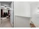 Hallway view featuring a white staircase and glimpses into the living area at 300 Gilman Ln # 101, Raleigh, NC 27610